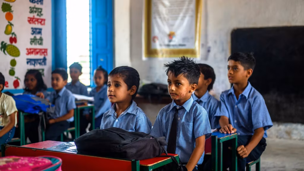 Children in school uniform sitting at their desks