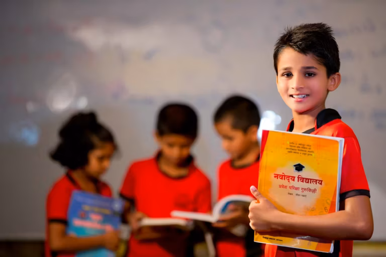 Children in school uniform reading Hindi books together